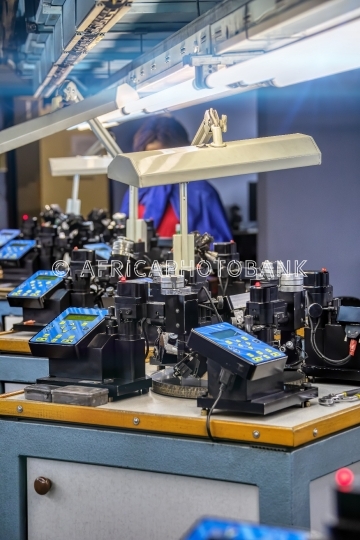 African woman working in a bruting diamond machine