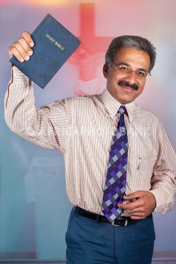 preacher holding holy bible