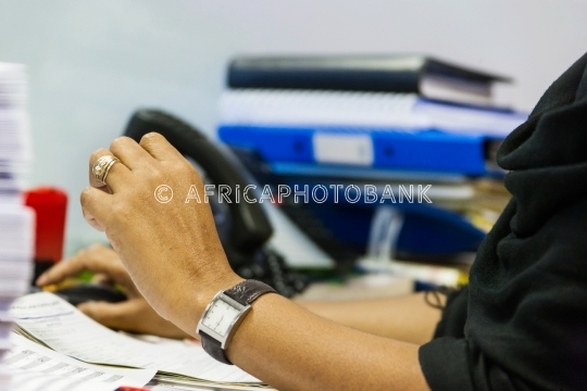 woman at a busy desk