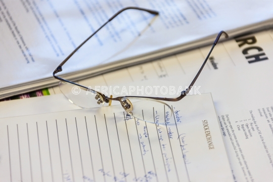 Glasses on stock exchange papers