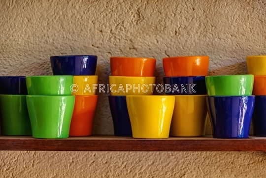 Colorful mugs on the shelf