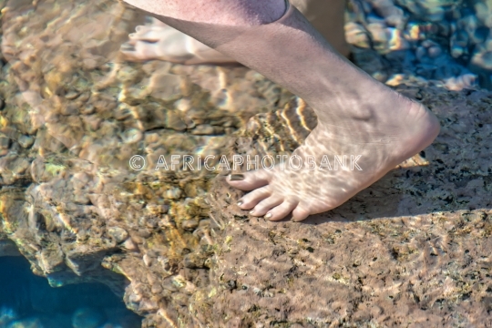 Barefoot woman feeling the ocean