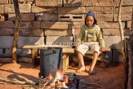African child cooking in the summer kitchen