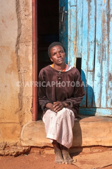 African woman in front of the house