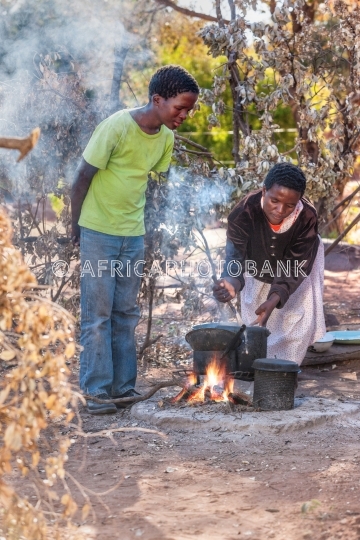 African family cooking in the summer kitchen