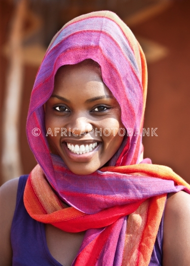 African woman in front of the house
