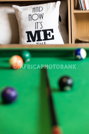 It’s me time snooker table and pillows in a shelf full with bo
