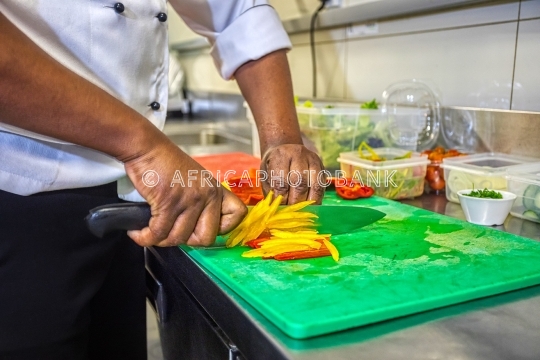 Chef cutting peppers