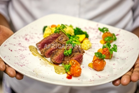 Chef with a steak plate